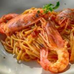 Pasta with red sauce and shrimp.